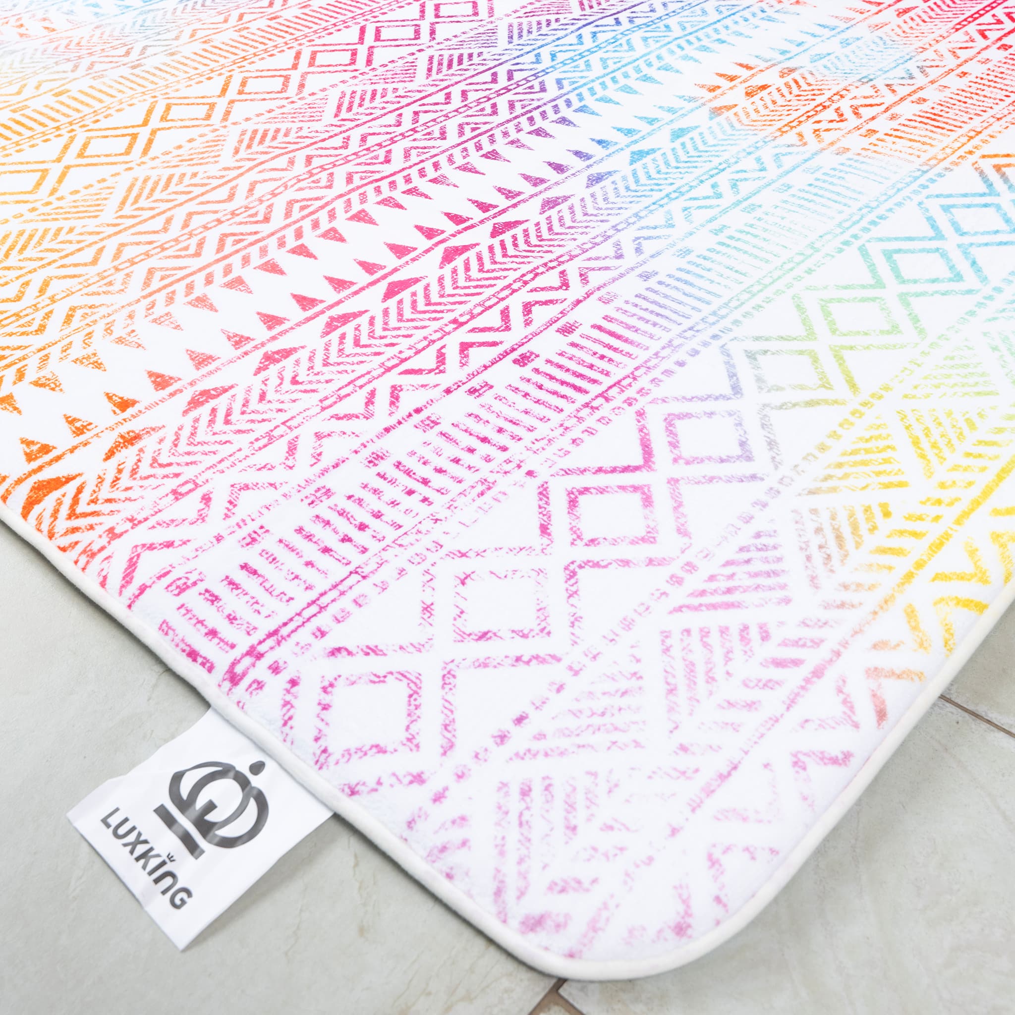 Colorful patterned rug with geometric designs on a light surface, featuring the brand 'Lukking'.