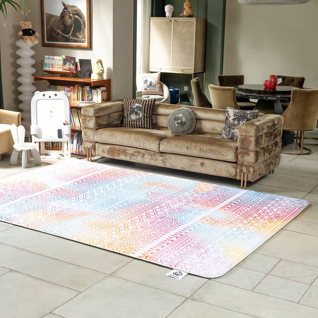 Living room with a patterned rug, sofa, and bookshelf.