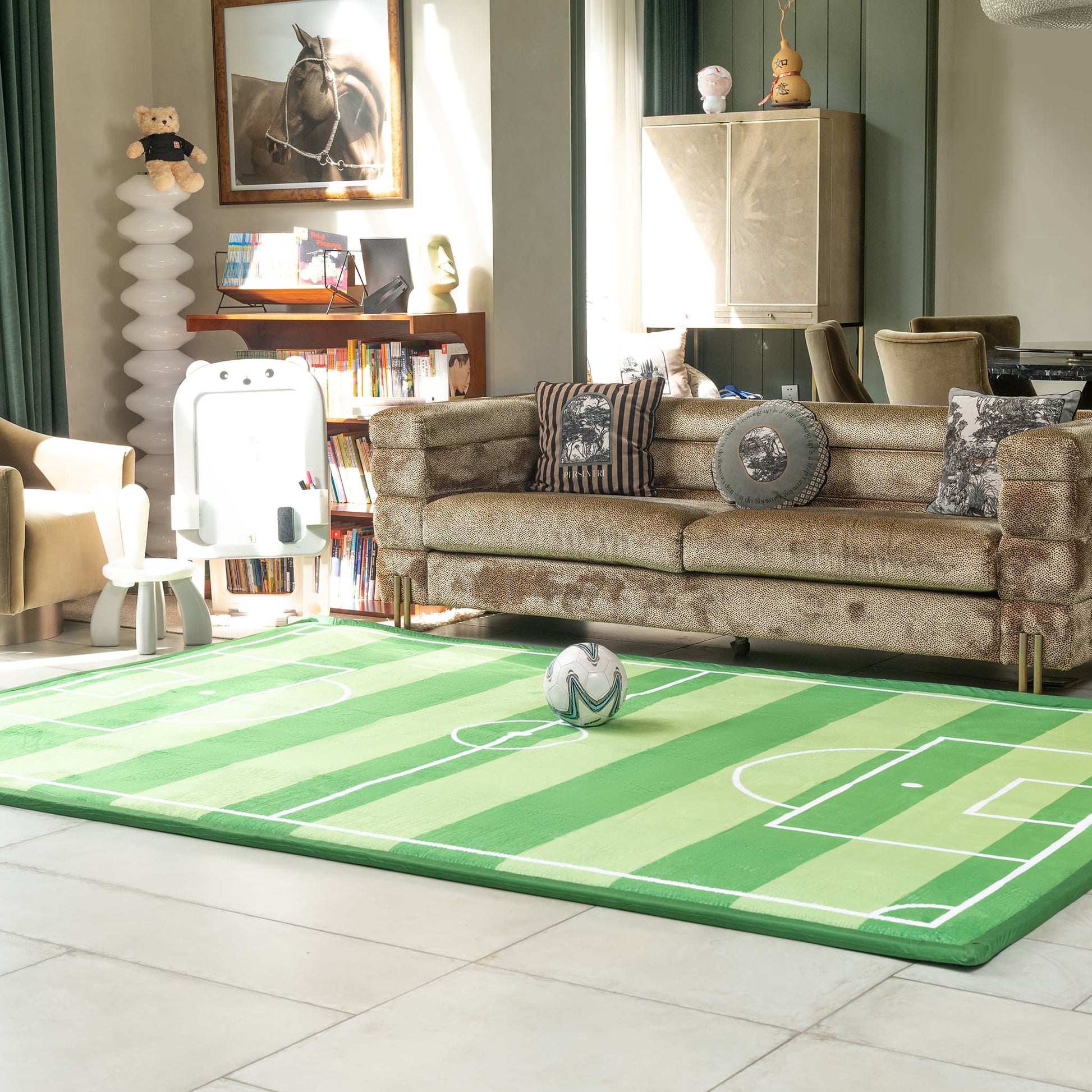 Living room with a green sports-themed rug, brown sofa, and decorative items.