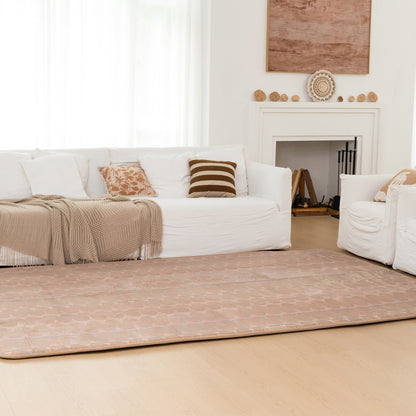 Living room with white sofa, beige rug, and decorative elements.