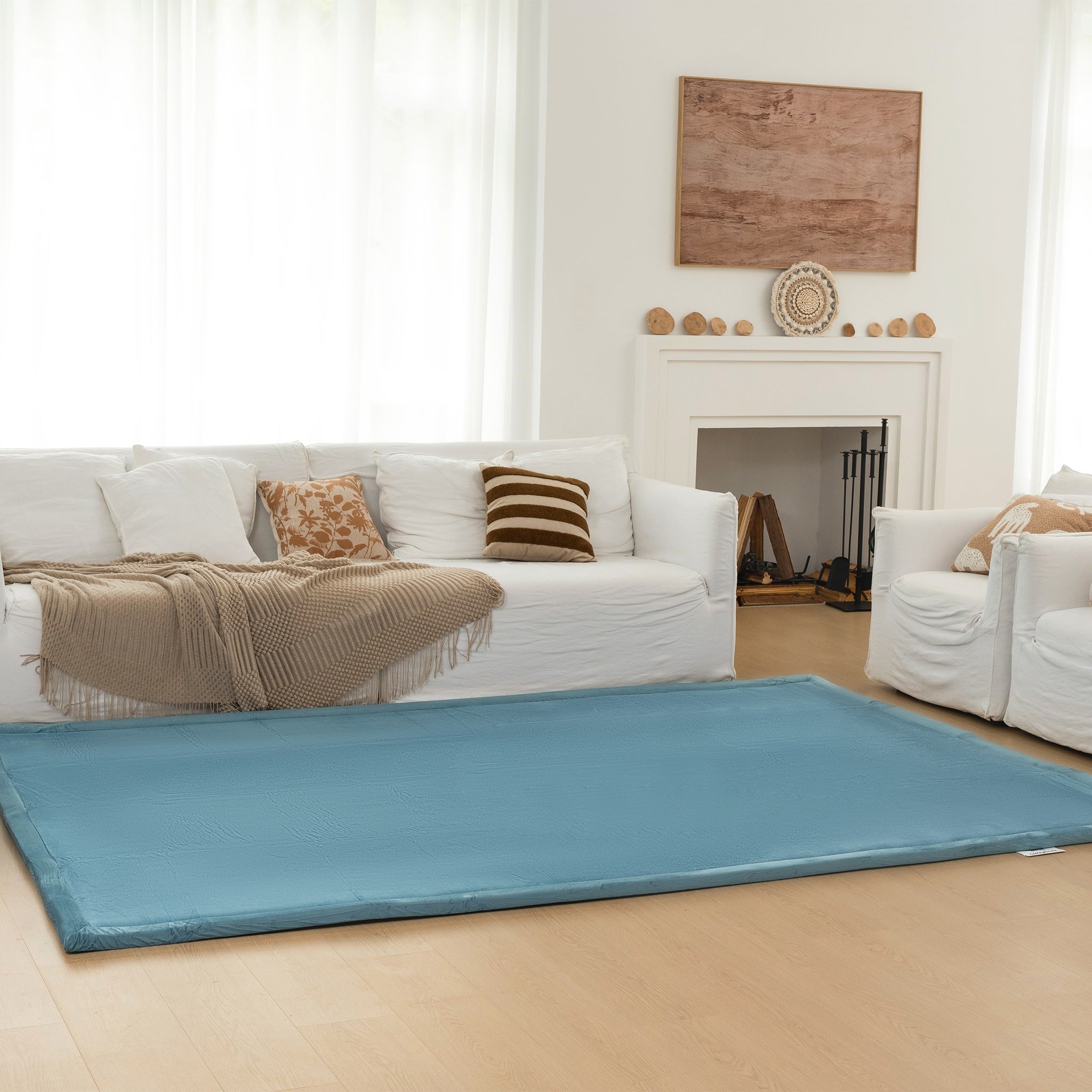 Blue pet mat in a living room with white furniture and decor.
