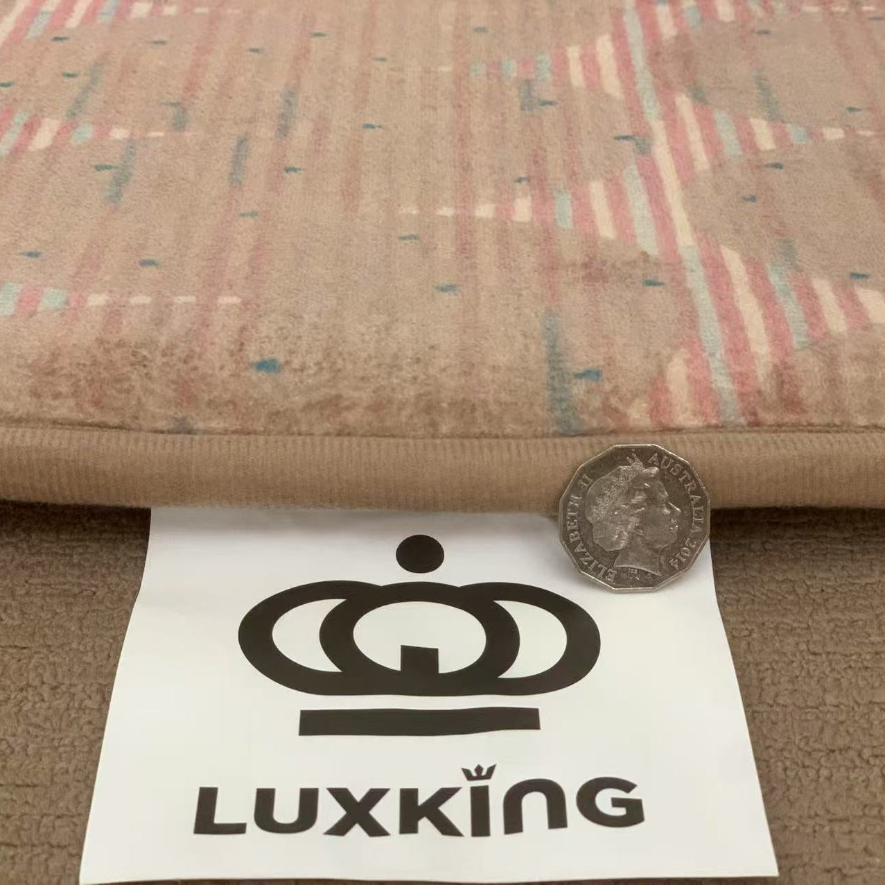 Luxking logo with a coin and paper on fabric background