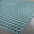 Close-up of a textured blue mat with circular patterns