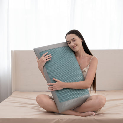 Woman holding a large, textured pillow on a bed