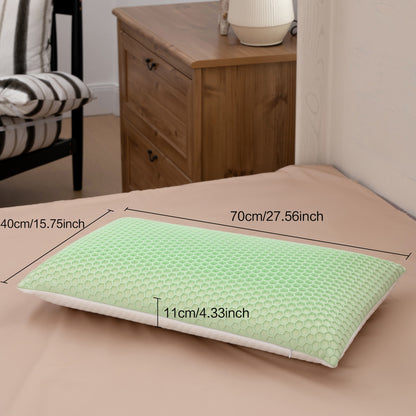 Green pillow with measurements on a bed in a bedroom setting