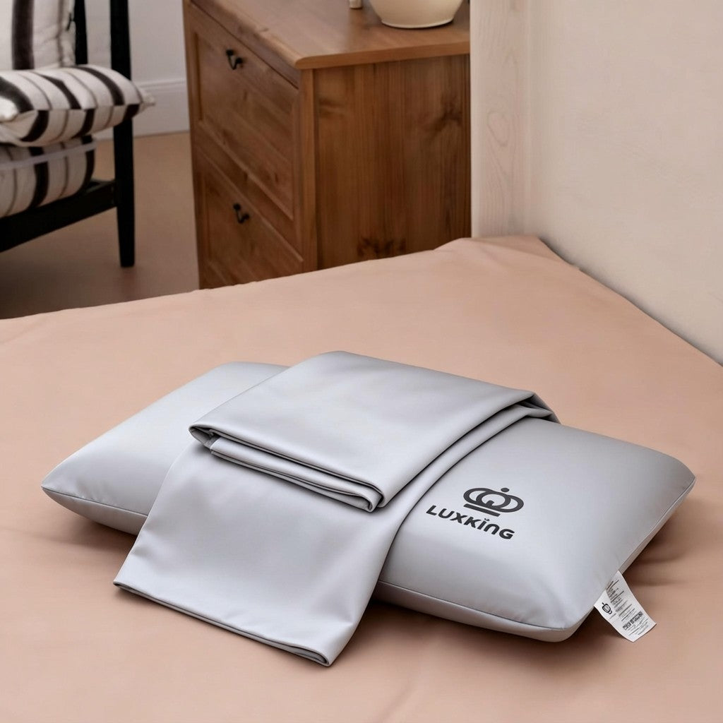 Gray pillow and blanket set with Luxking logo on a bed in a bedroom setting.