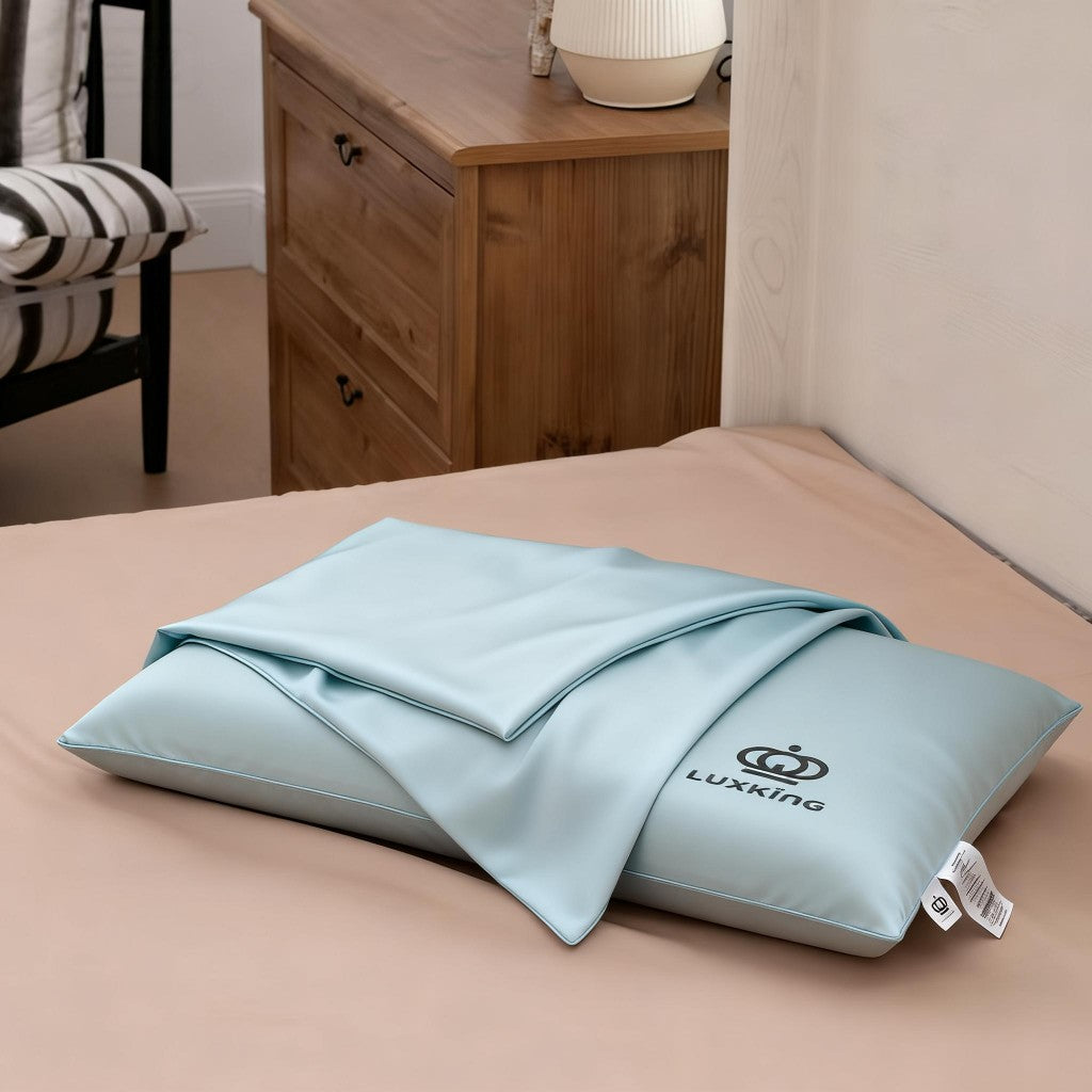 Light blue pillow with Luxking logo on a bed in a bedroom setting