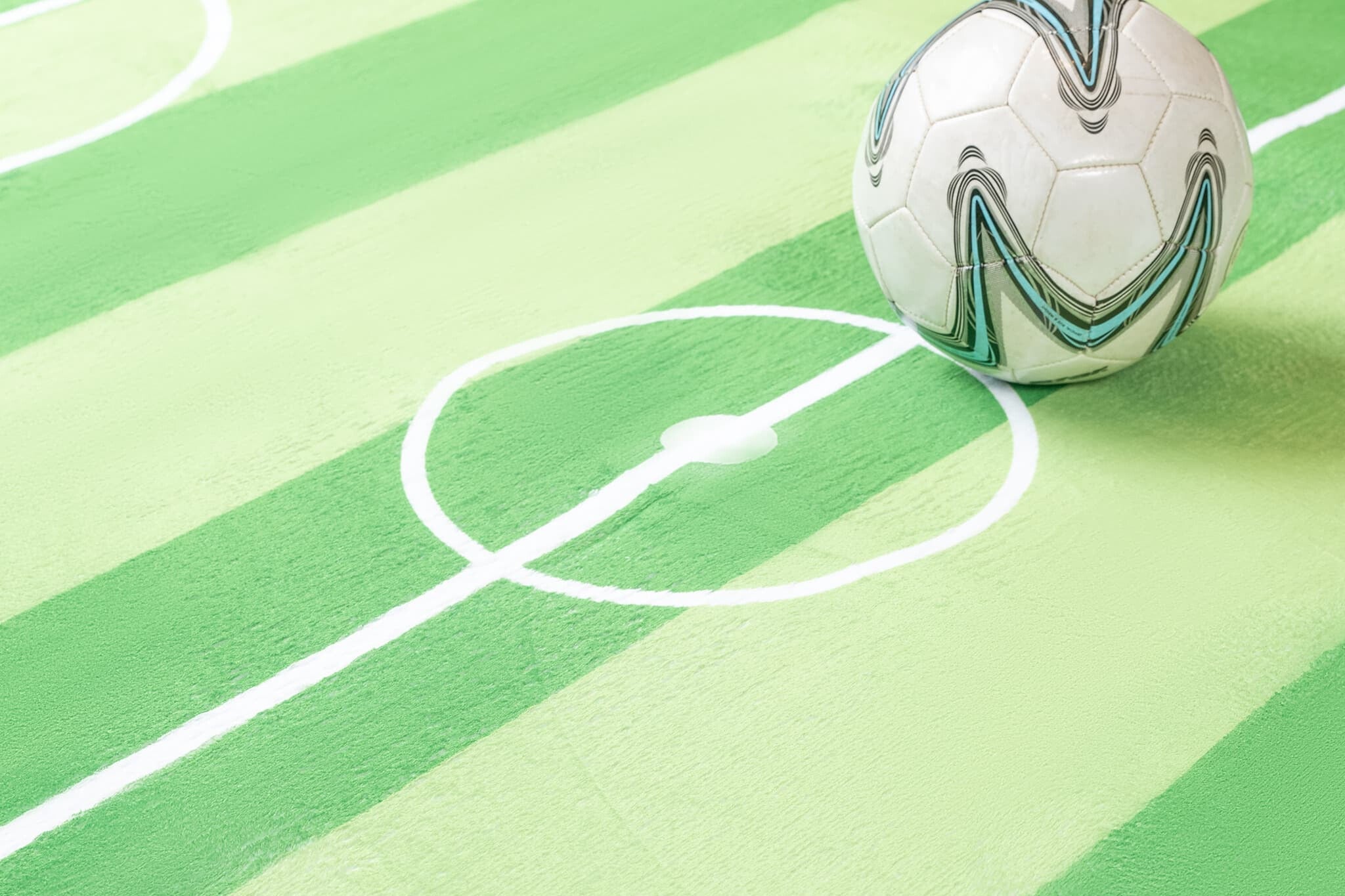 Soccer ball on a green sports Luxking cloud mat with white lines