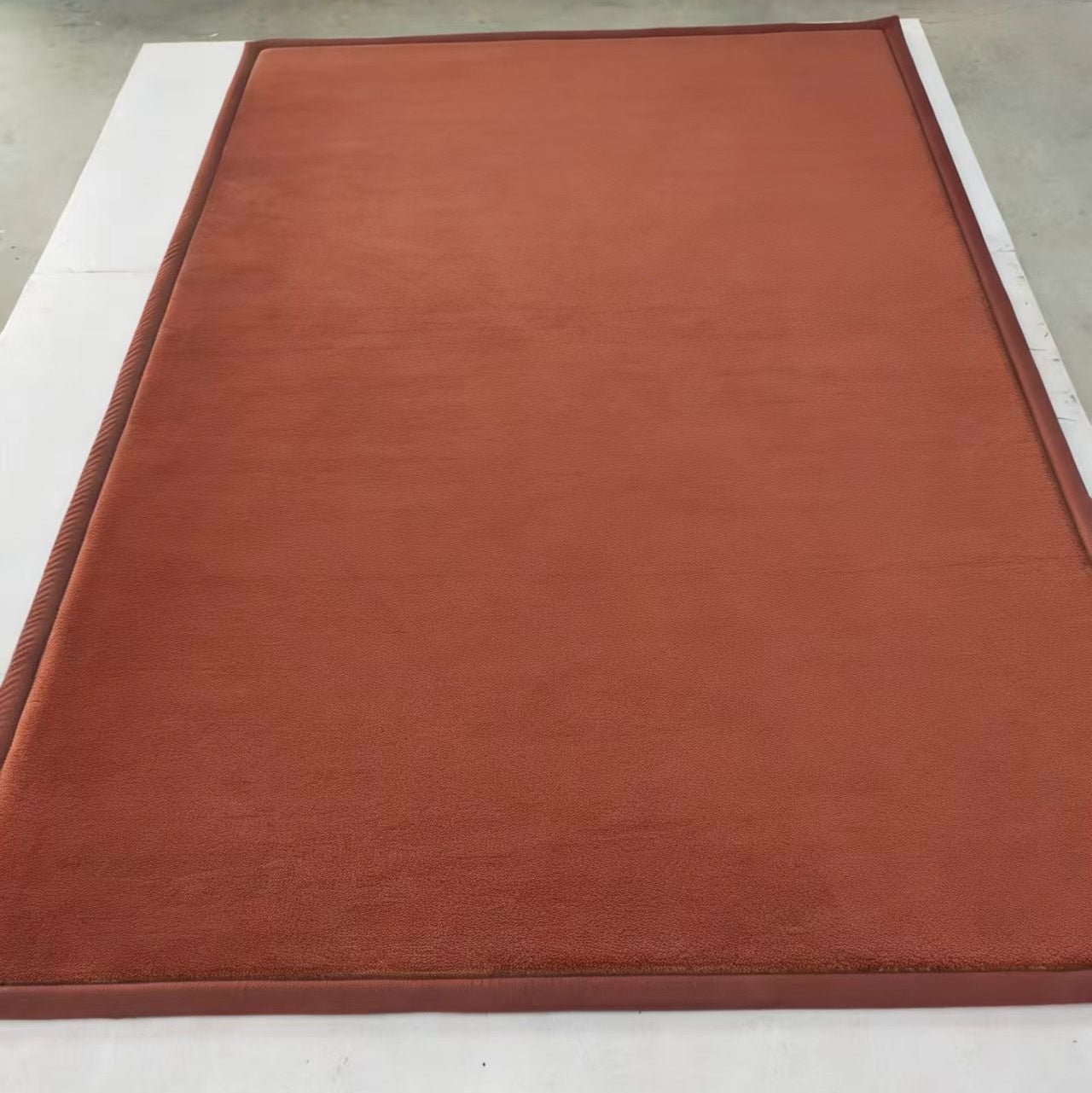 Brown mat on a white surface with a ruler for scale