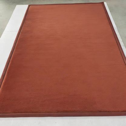 Brown mat on a white surface with a ruler for scale