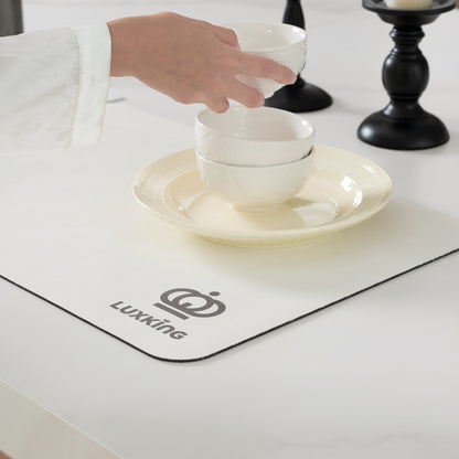 White ceramic bowls being placed on a white plate with Luxking logo on a placemat.