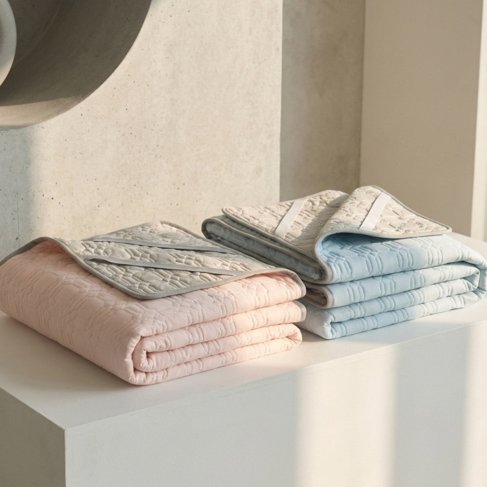Folded textured towels in pastel colors on a light surface with a neutral background
