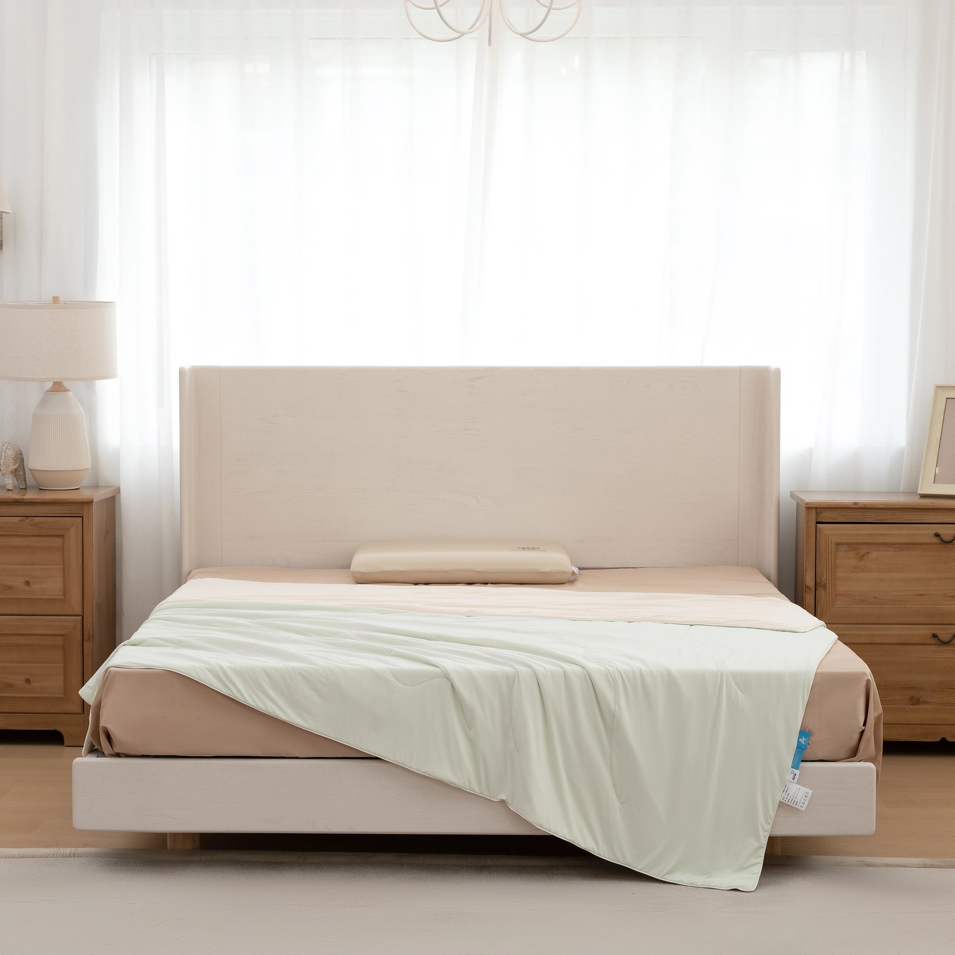 Beige bed with white bedding in a bedroom setting