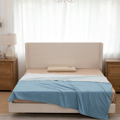 Beige bed with blue bedding in a bedroom setting