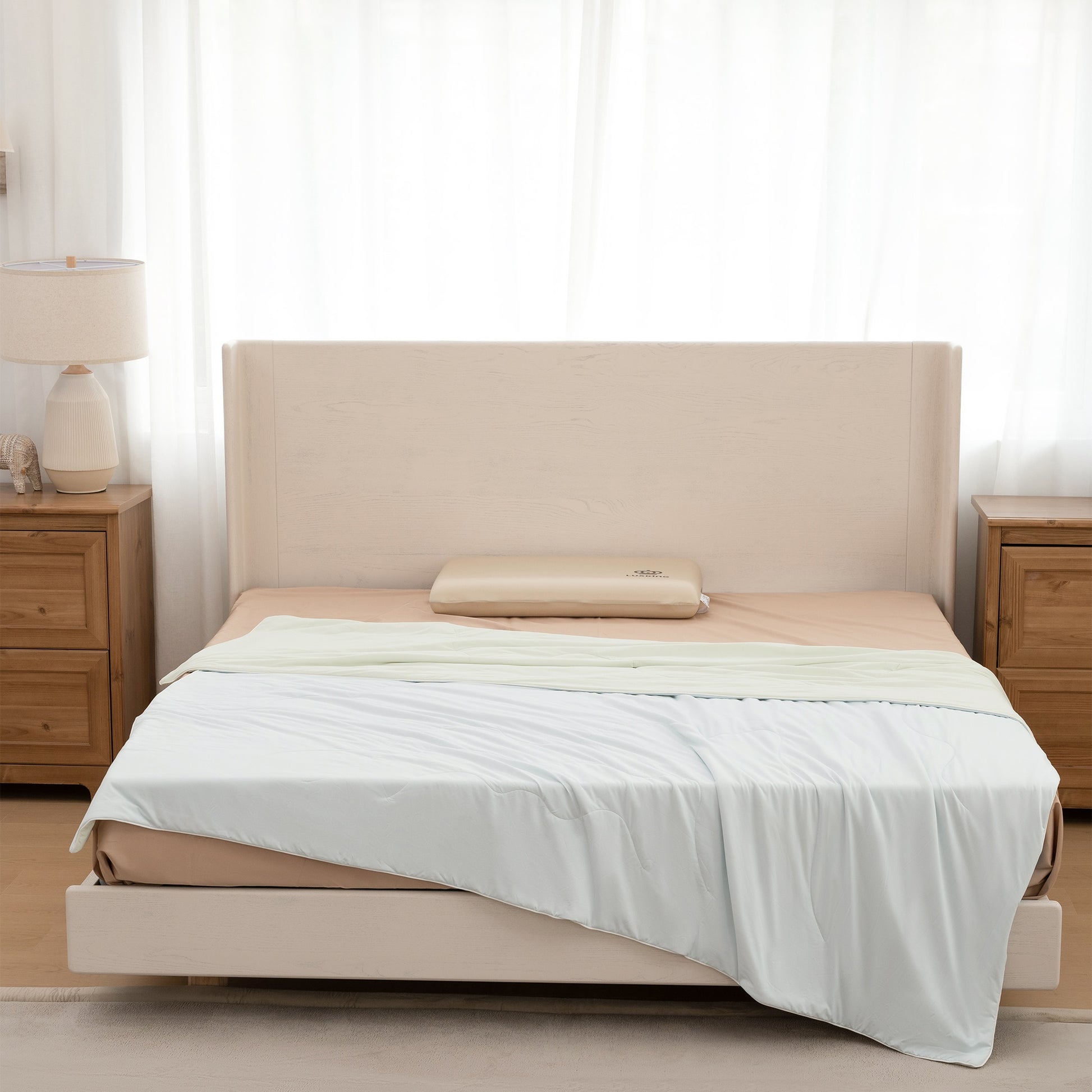 Beige bed with white bedding in a bedroom setting